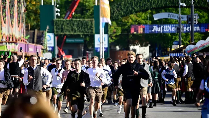 Munich Erupts: Thousands Storm Oktoberfest for Coveted Tent Seating
